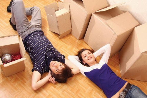 Removal team preparing furniture for transport from a family home